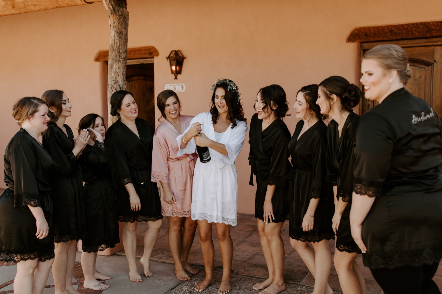 The bride with her bridesmaids popping some champagne before the ceremony