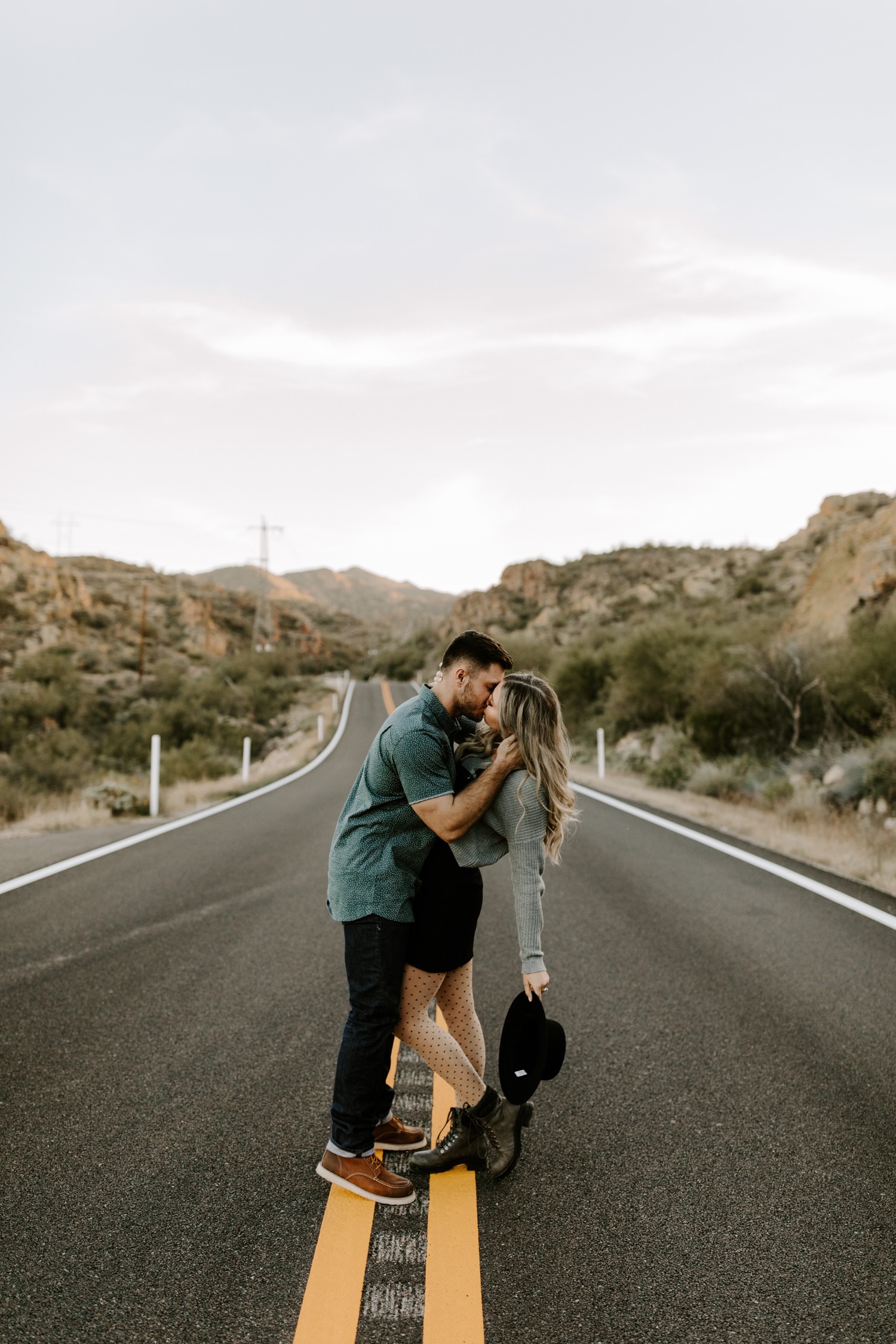 This couple is kissing in the middle of the road in the desert of Arizona
