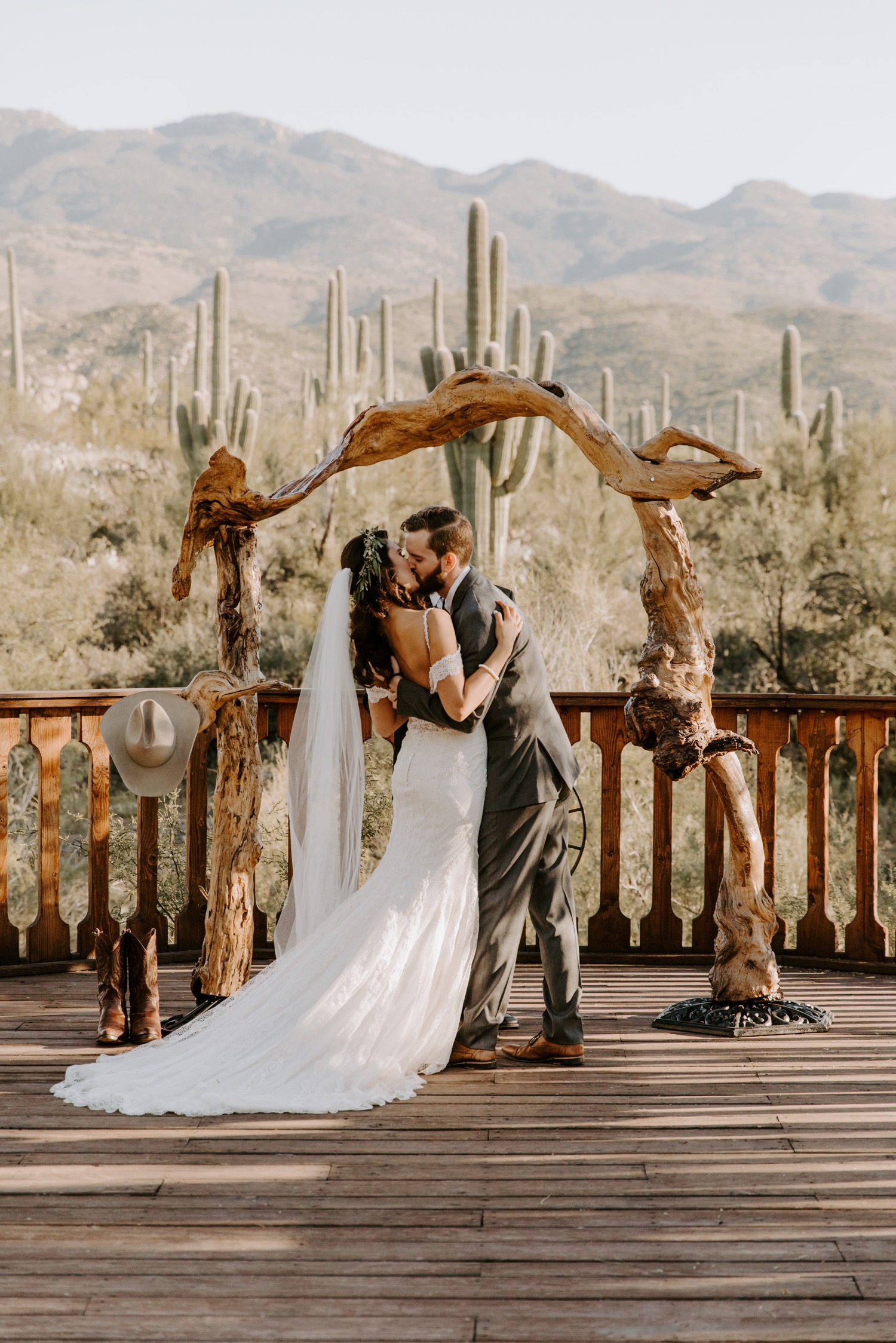Bride and groom first kiss at ceremony location at Tanque Verde Ranch wedding venue in tucson arizona for a desert inspired wedding