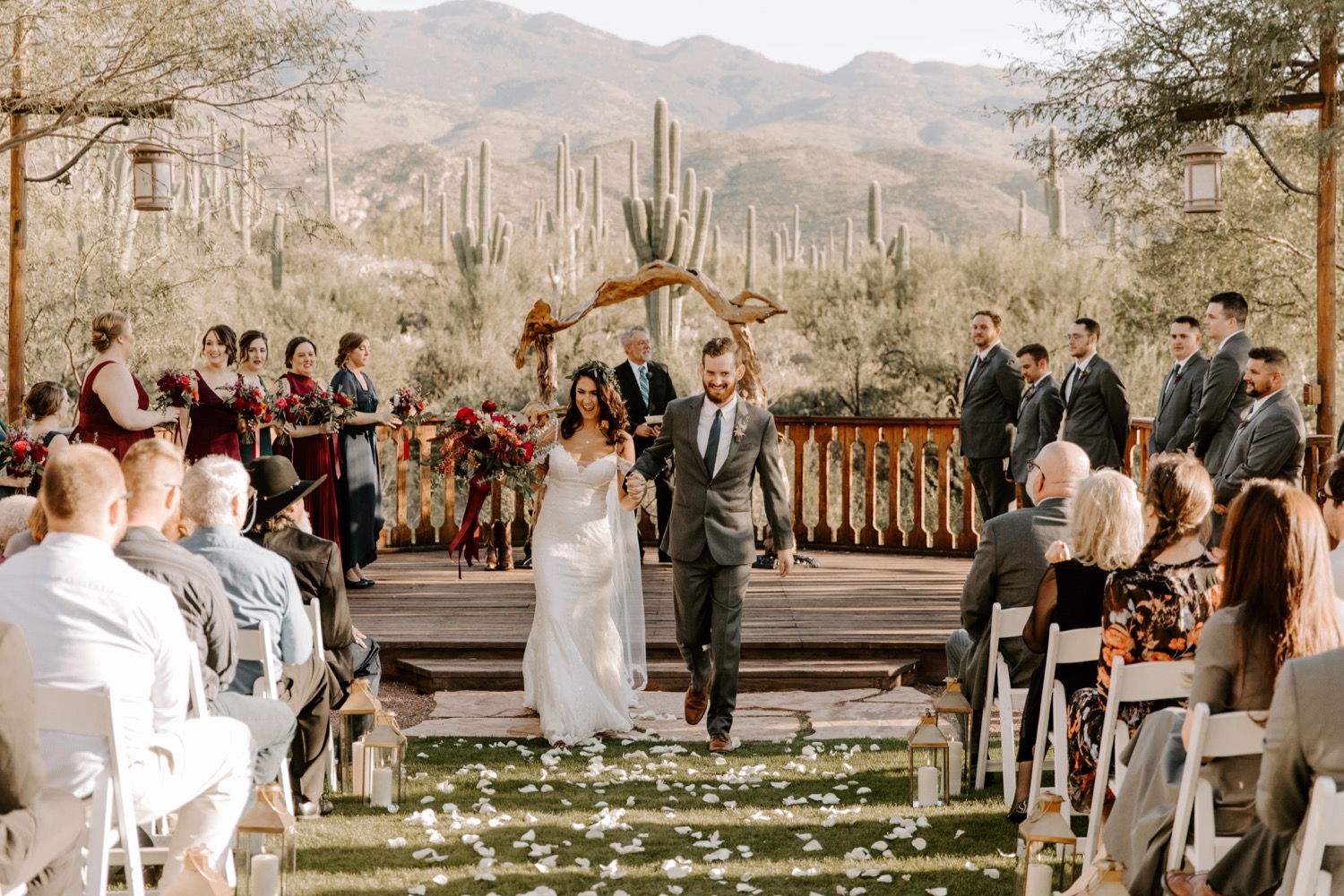 Bride and groom celebrating after their wedding ceremony at Tanque Verde Ranch with a desert cactus landscape backdrop