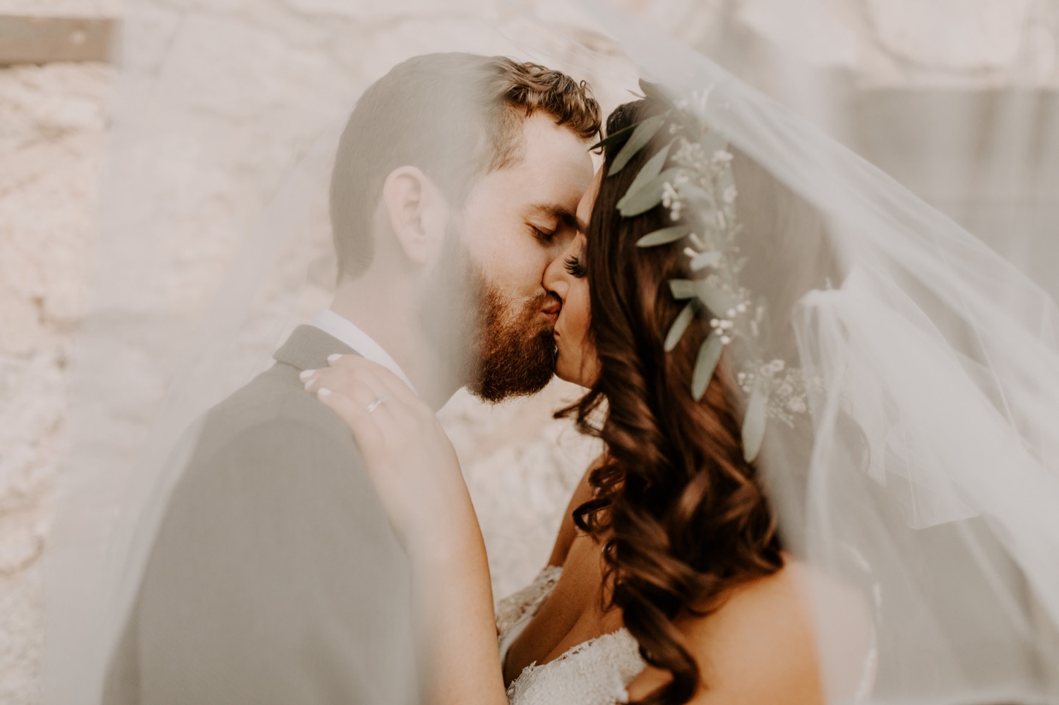 Married kisses under the veil.