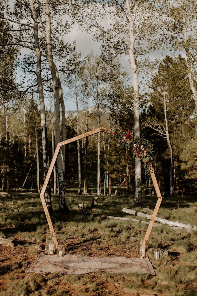 Ceremony arch in the woods with fall colors