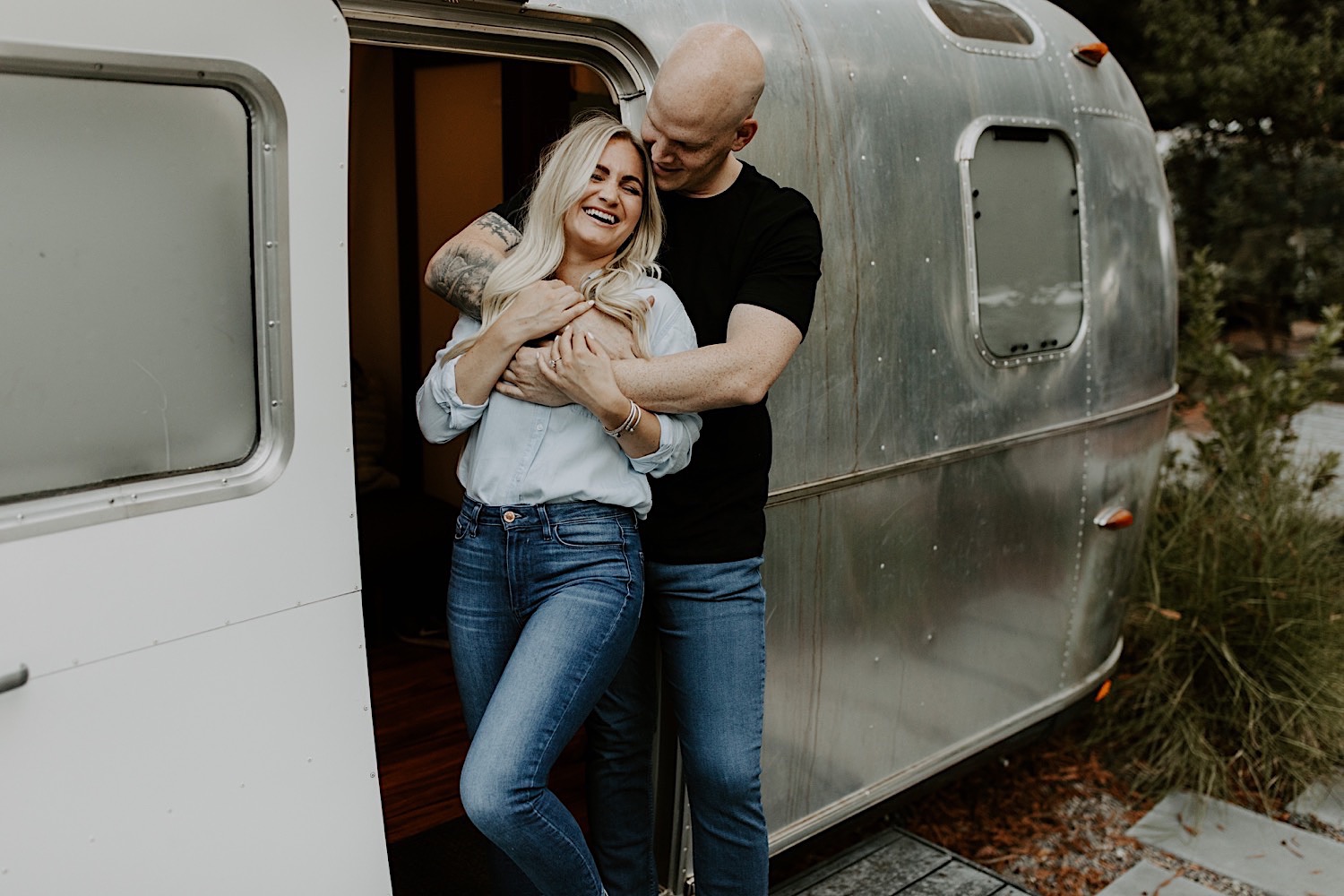 Couple snuggling in airstream at Russian River Autocamp