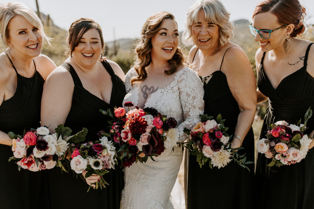 A bride with her bridesmaids and wedding bouquets